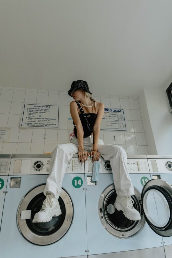 girl sitting on washing machine